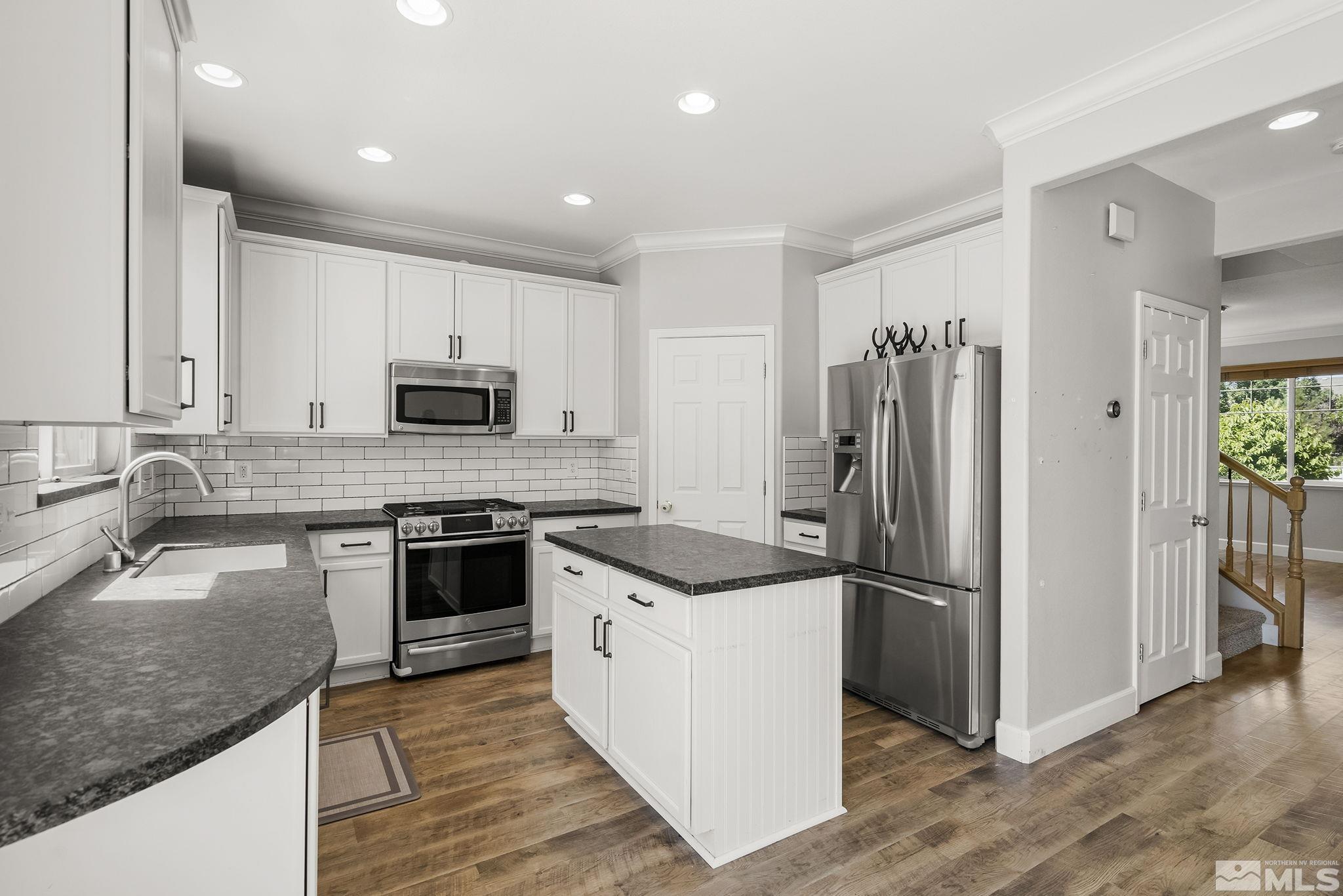 2336 Clementine Lane Reno, NV 89521 - Photo 8 of 31 a kitchen with granite countertop a refrigerator stove and sink
