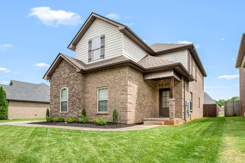 a front view of a house with a yard and garage