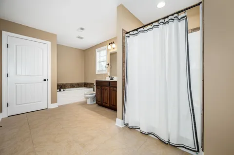 a view of a bathroom with tub and sink