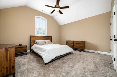 a bedroom with a bed dresser and a window