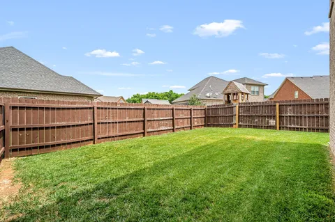 a view of a backyard with a garden and deck
