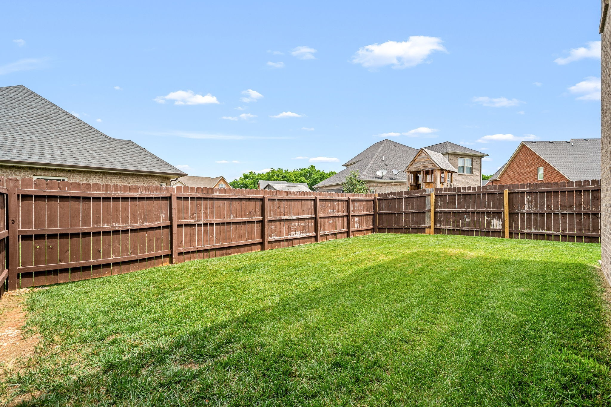 2816 Lightning Bug Drive Murfreesboro, TN 37129 - Photo 23 of 23 a view of a backyard with a garden and deck