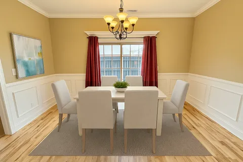 a dining room with furniture and window