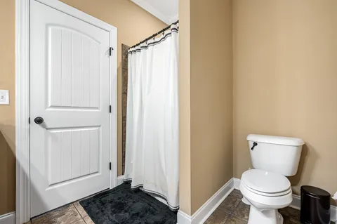 a bathroom with a toilet and a shower