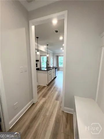 a view of a kitchen and wooden floor