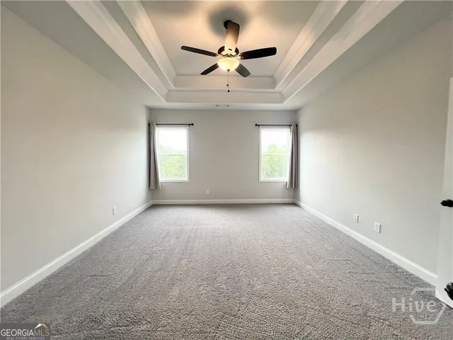 a view of empty room with ceiling fan