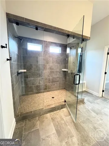 a bathroom with a bathtub and a shower
