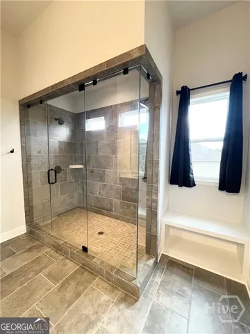 a bathroom with a double vanity sink mirror and shower