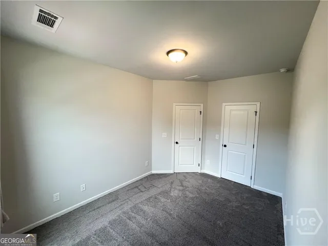 a view of an empty room and a window