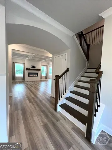 a view of entryway and hall with wooden floor