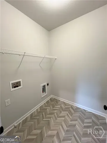 a big white house with a big yard and large trees