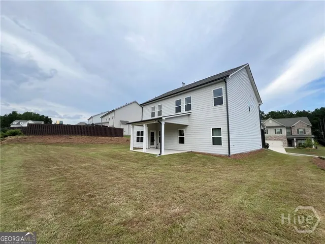 a big house with a big yard and large trees