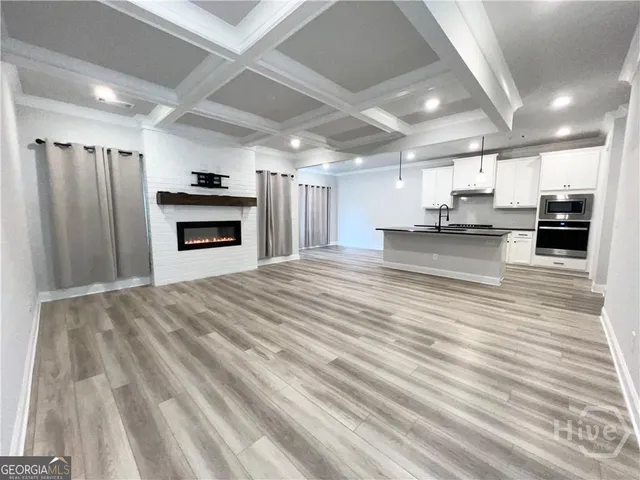 a large kitchen with kitchen island a stove a refrigerator a sink and a stove