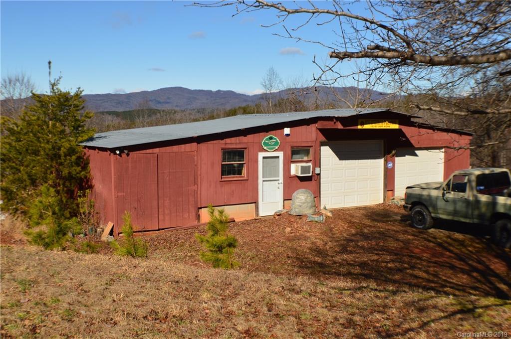 2395 Cove Road Rutherfordton, NC 28139 - Photo 1 of 25 a backyard of a house with table and chairs under an umbrella