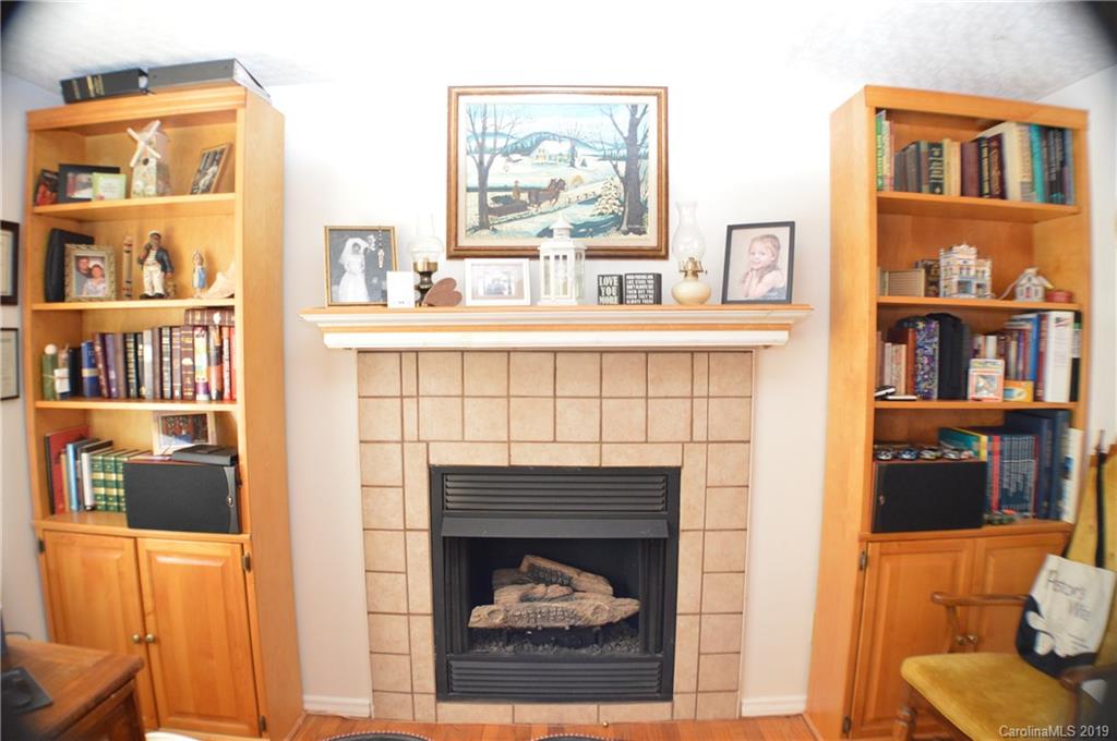 2395 Cove Road Rutherfordton, NC 28139 - Photo 14 of 25 a living room with a fireplace and a floor to ceiling window