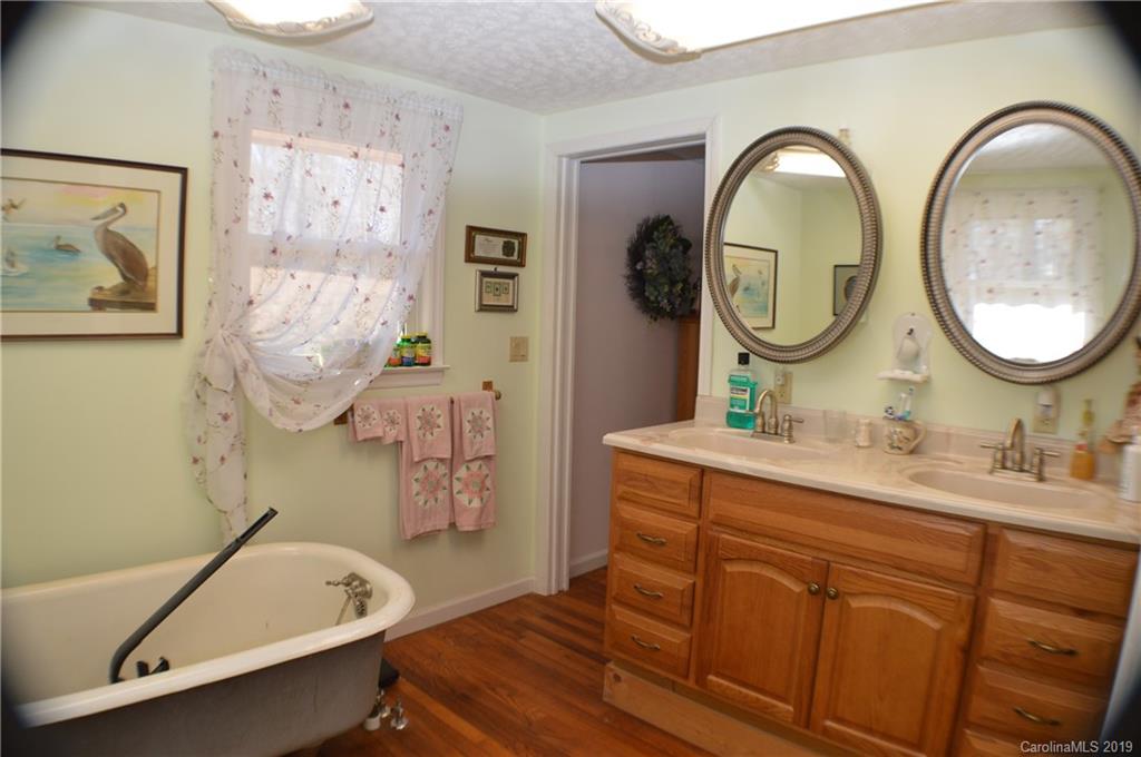 2395 Cove Road Rutherfordton, NC 28139 - Photo 3 of 25 a bathroom with a tub sink and mirror