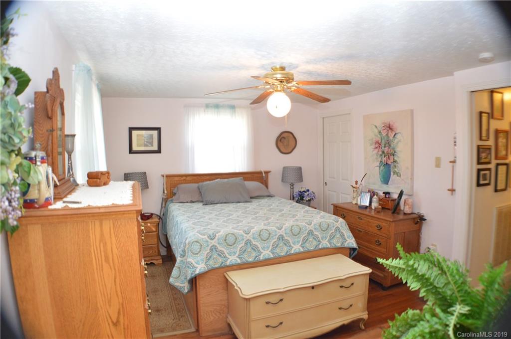 2395 Cove Road Rutherfordton, NC 28139 - Photo 5 of 25 a bedroom with a bed and a chandelier