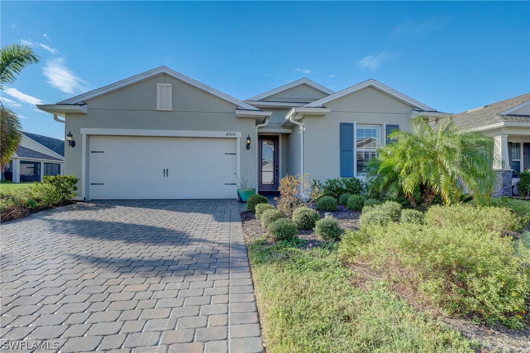 43038 Parkside Court Babcock Ranch, FL 33982 - Photo 1 of 3 a front view of a house with a yard and garage