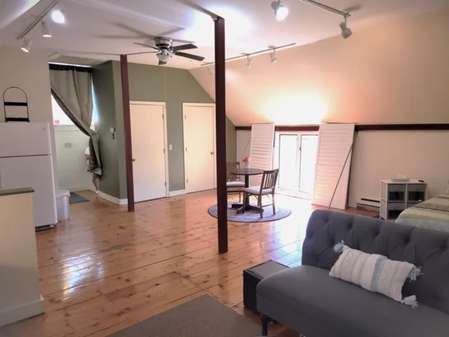 a living room with furniture and wooden floor