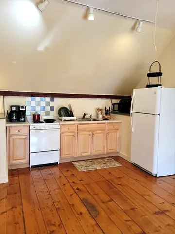 a kitchen with a sink a stove and cabinets