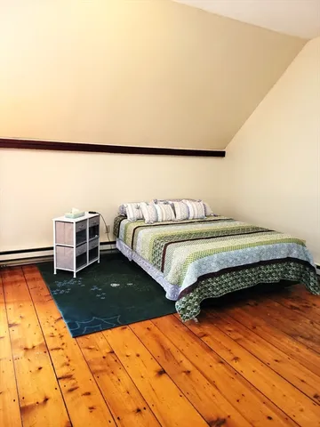 a bedroom with a bed and a rug