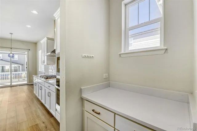 a kitchen with a stove and a wooden floor