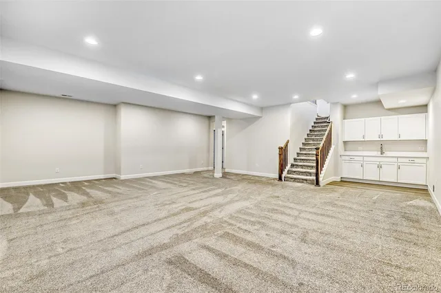 a view of an empty room with stairs and ventilation