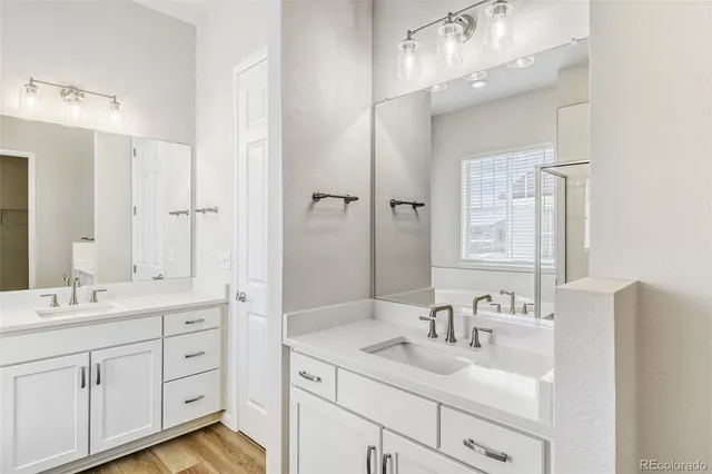 a bathroom with a double vanity sink mirror and