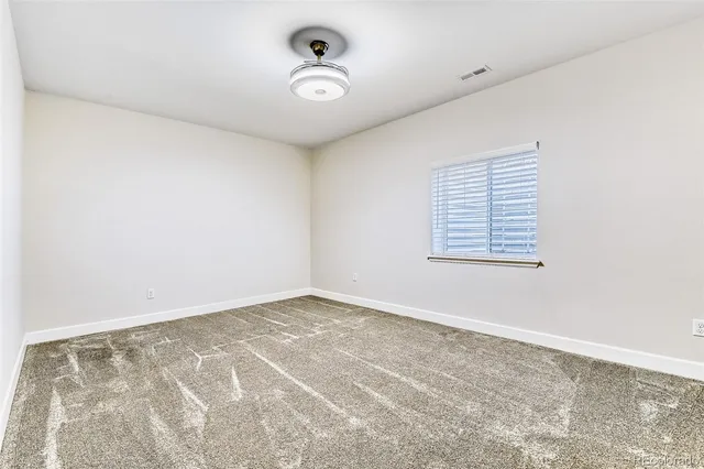 an empty room with a empty space and windows