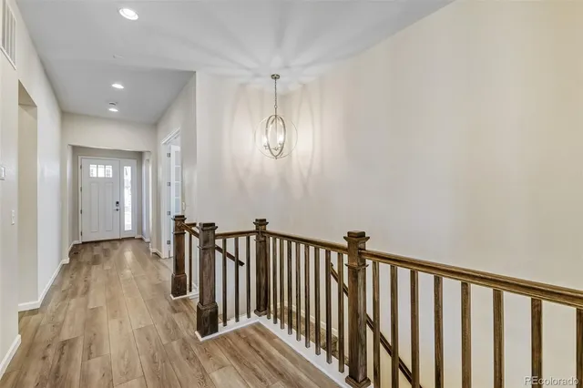a view of a hallway with wooden floor
