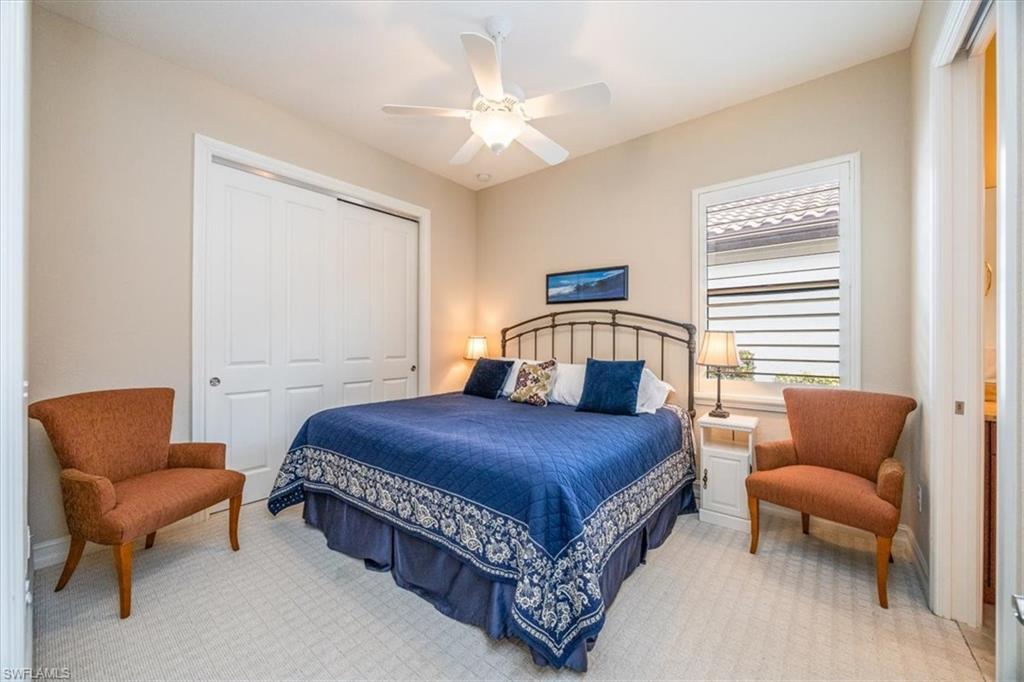 6504 Costa Circle Naples, FL 34113 - Photo 13 of 25 Bedroom with ceiling fan, a closet, and light carpet