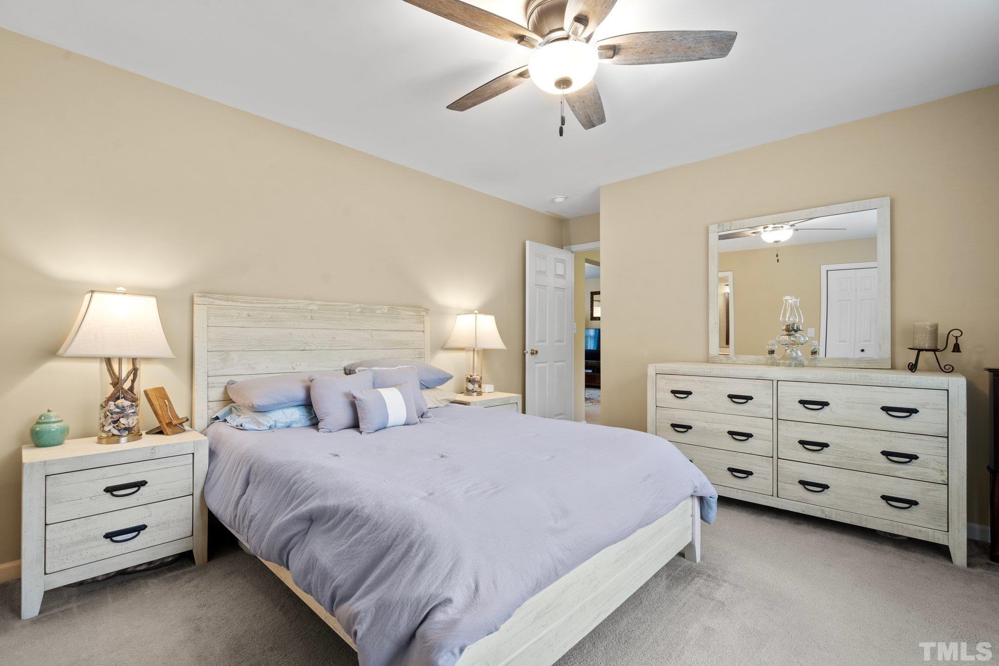 2613 Old Allensville Road Roxboro, NC 27574 - Photo 18 of 35 a bedroom with a bed and a chandelier