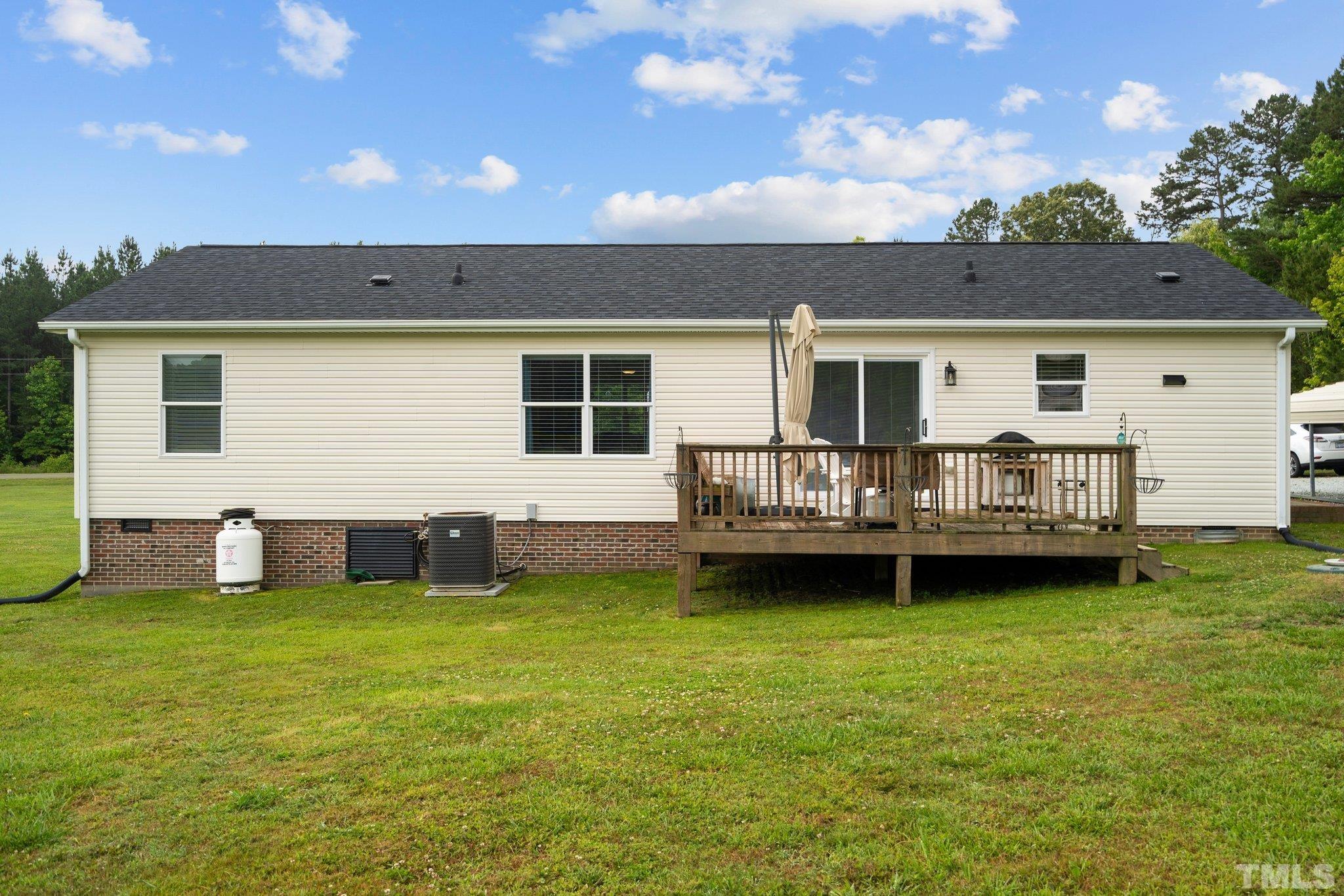 2613 Old Allensville Road Roxboro, NC 27574 - Photo 30 of 35 a view of a house with yard and deck