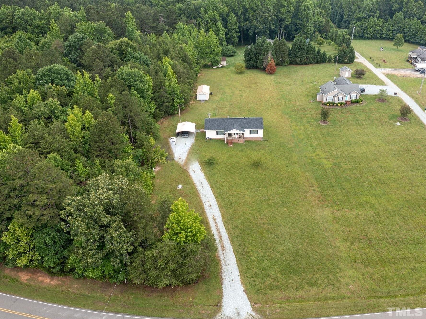 2613 Old Allensville Road Roxboro, NC 27574 - Photo 31 of 35 a view of a lake with a house