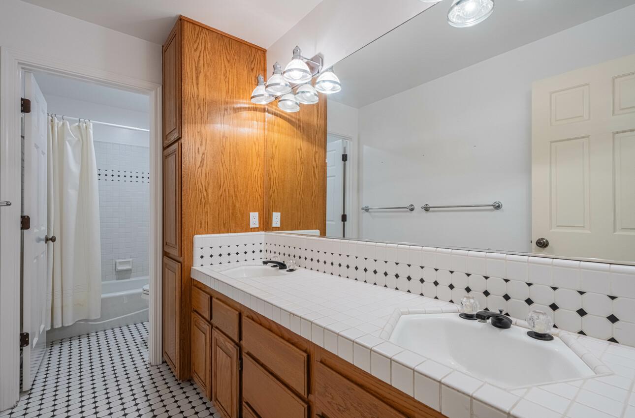 4055 Sunset Lane Pebble Beach, CA 93953 - Photo 20 of 23 a bathroom with a sink a vanity and a mirror