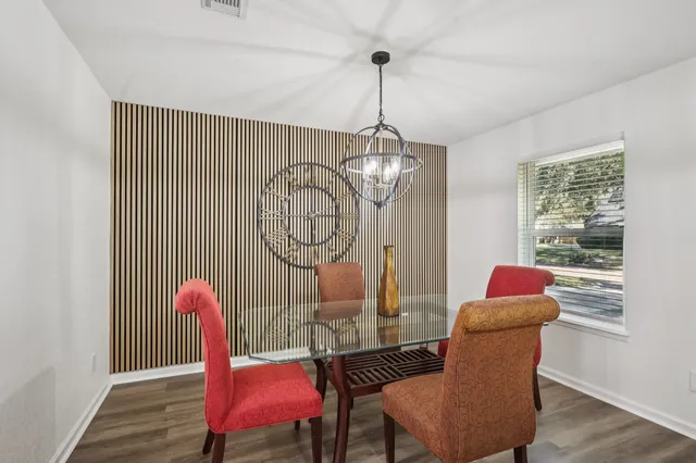 a living room with furniture a fireplace and a large window