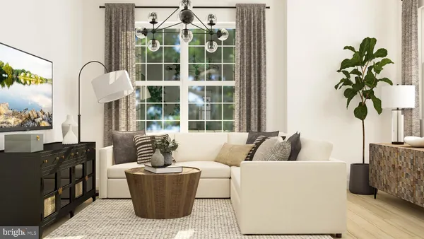 a living room with furniture and a potted plant