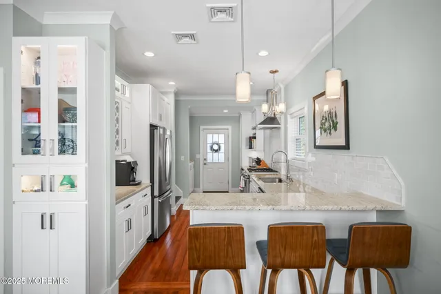 a dining room with furniture and a chandelier