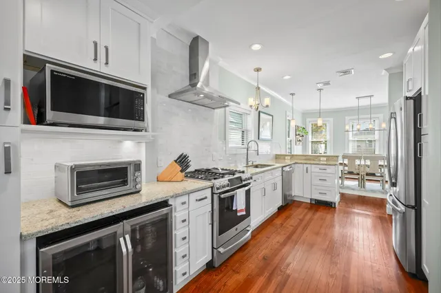 a kitchen with stainless steel appliances a stove microwave and cabinets