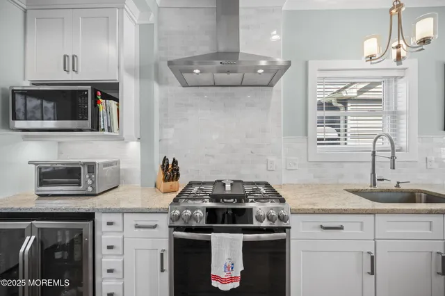 a kitchen with granite countertop a stove and a sink