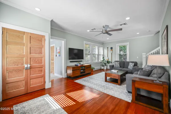 a living room with furniture potted plant and a flat screen tv