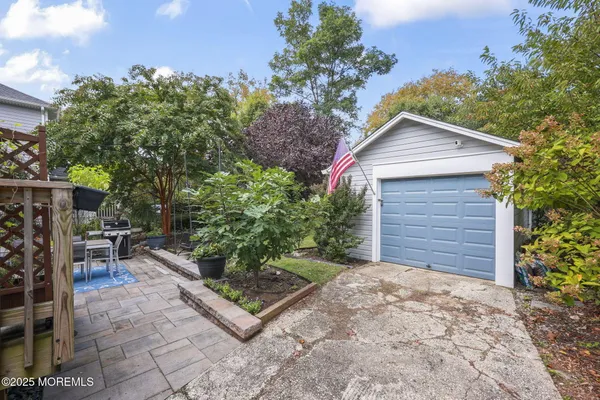 a backyard of a house with barbeque oven and outdoor seating