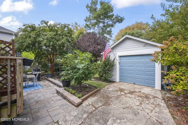 a backyard of a house with barbeque oven and outdoor seating