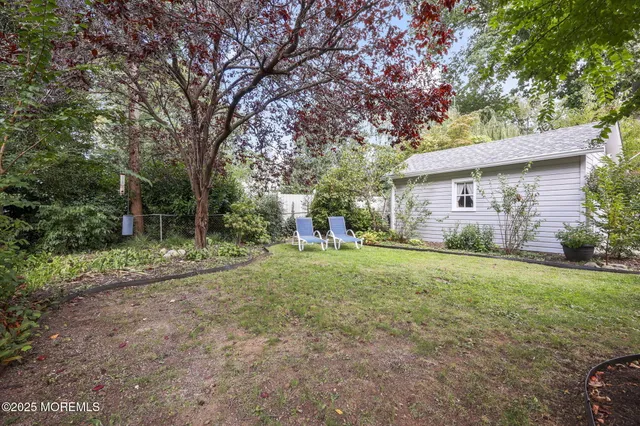 a view of a house with backyard and sitting area
