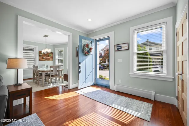 a living room with furniture a dining table and wooden floor