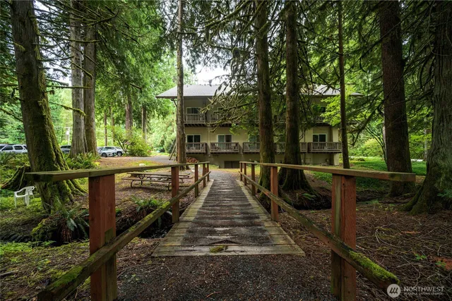an aerial view of a house with swimming pool and sitting space