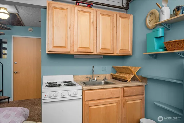 a kitchen with stainless steel appliances granite countertop a washer and dryer