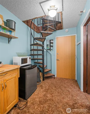a view of a livingroom with furniture and stairs