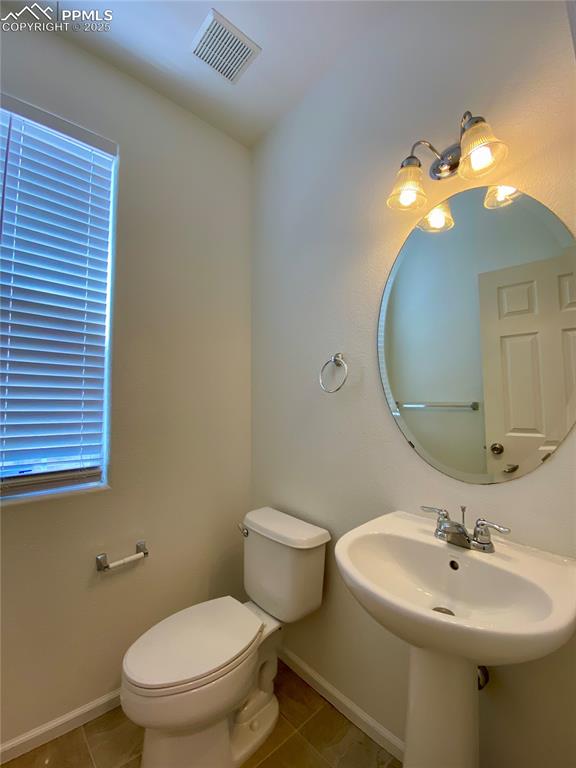 7513 Sandy Springs Point Fountain, CO 80817 - Photo 12 of 38 a bathroom with a toilet sink and mirror