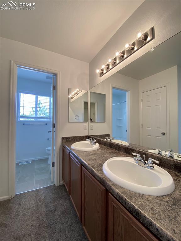 7513 Sandy Springs Point Fountain, CO 80817 - Photo 17 of 38 a bathroom with a granite countertop sink and a mirror